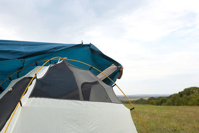 Installed tourist tent in nature in the forest. domestic tourism, active summer holidays, family 