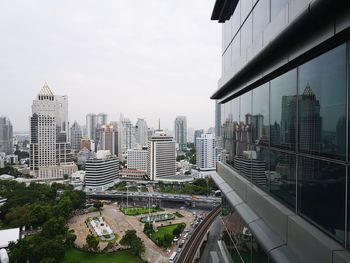 Modern buildings in city against sky