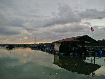 Scenic view of lake by buildings against sky