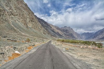 Road amidst mountains against sky