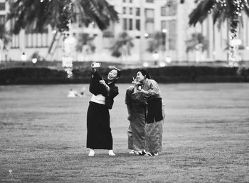 Friends standing on grass