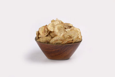 Close-up of bread in bowl against white background