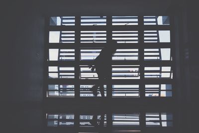 Close-up of silhouette person against window