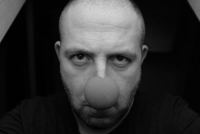 Close-up portrait of man wearing clown