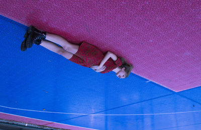 Young woman lying on basketball court