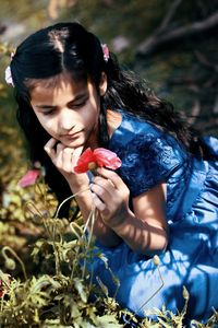 Close-up of girl holding plant