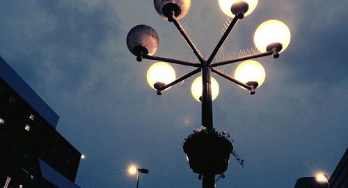 Low angle view of illuminated street light against sky at night