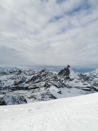 Scenic view of snow covered mountains against sky