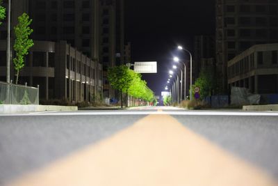 Surface level of street amidst buildings at night