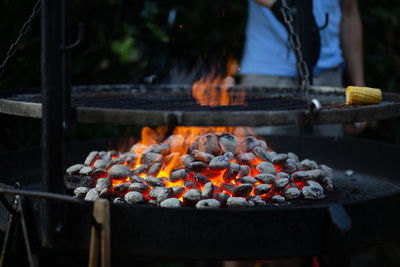 Corn on barbecue grill with person in background