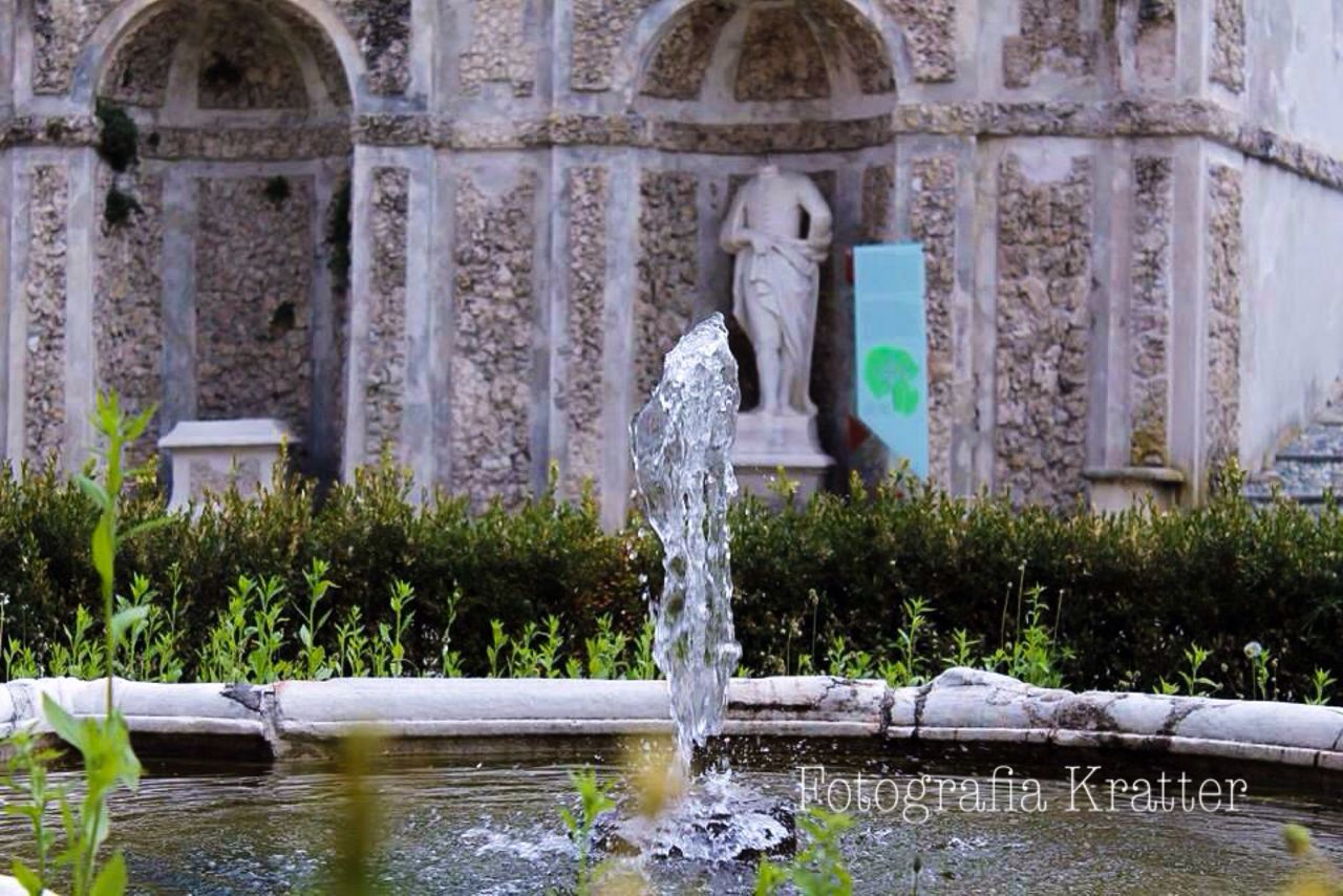 fountain, water, building exterior, built structure, architecture, statue, sculpture, human representation, art, plant, art and craft, pond, creativity, splashing, spraying, one person, tree, day, motion