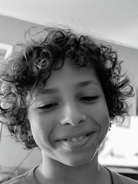 Close-up of smiling boy with curly hair