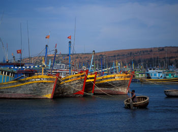 Fishing boats moored at harbor 