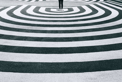 Woman standing on stripped asphalt ground