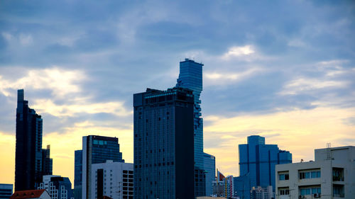 Low angle view of buildings against sky during sunset