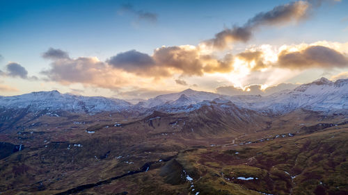 Scenic view of snowcapped mountains against sky during sunset