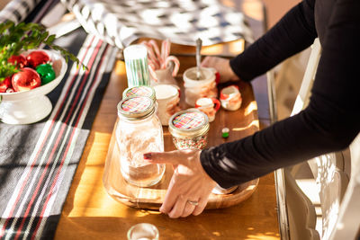 High angle view of hand holding drink on table