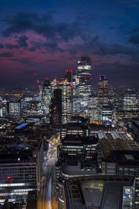 High angle view of illuminated cityscape against sky at night