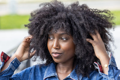 Portrait of young woman with curly hair