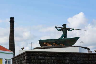 Low angle view of statue against building