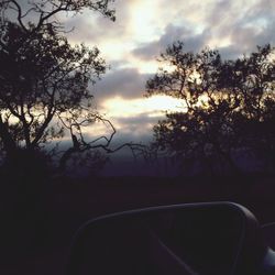 View of road against cloudy sky at sunset