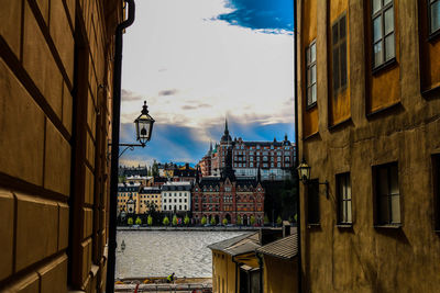 Residential buildings against cloudy sky