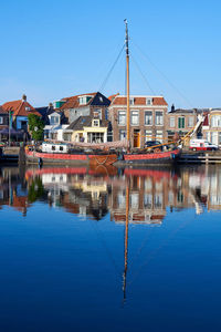 An old flat bottomed ship in the port of lemmer on the ijsselmeer in the netherlands