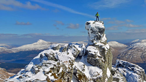 Figure on top of rocky pinnacle