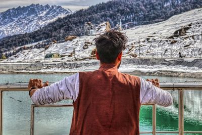 Rear view of man looking at mountains