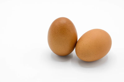 Close-up of eggs against white background