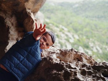 High angle view of young woman standing on rock formation