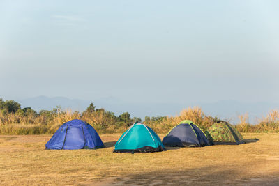 Tent on field against sky