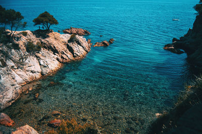 High angle view of rocks on sea