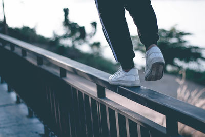 Low section of person standing on bridge