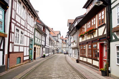 Street amidst buildings against clear sky