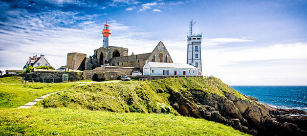 Temple by sea against sky