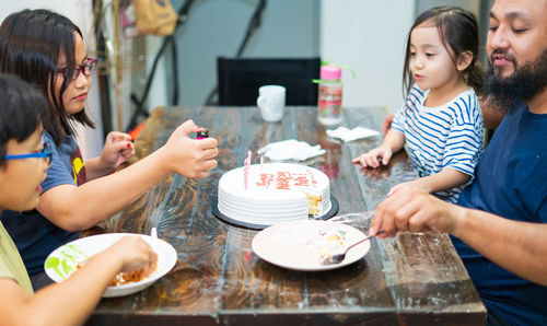 Family celebrating birthday at home