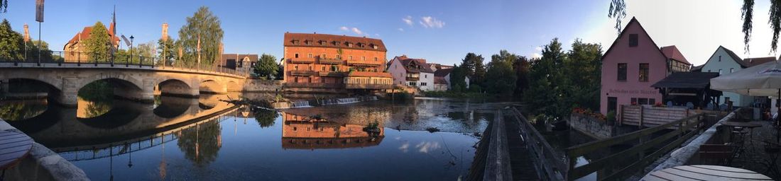 Panoramic of old town bridge over canal near sidewalk caf