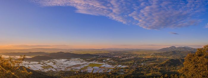 Aerial view of townscape against sky at sunset