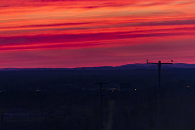 Scenic view of silhouette mountains against orange sky