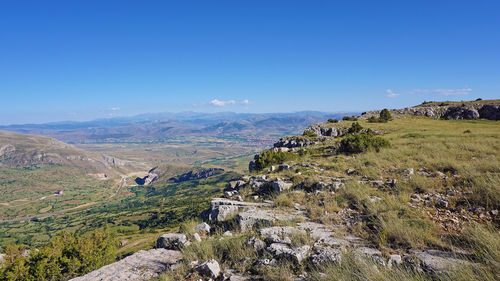 Scenic view of landscape against blue sky