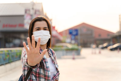 Portrait of young woman standing on street