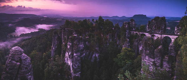 Panoramic view of trees and mountains against sky