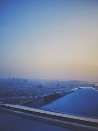 Aerial view of cityscape against sky during sunset