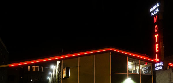 Low angle view of illuminated building against sky at night