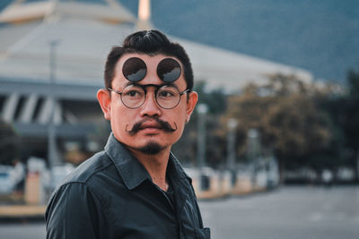 Man looking away while wearing eyewear