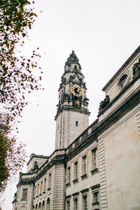 Low angle view of clock tower against sky