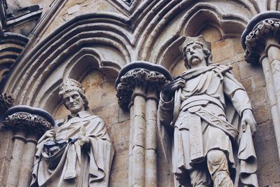 Low angle view of statues against the wall