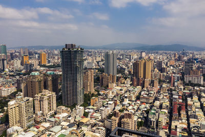 High angle view of modern buildings in city against sky