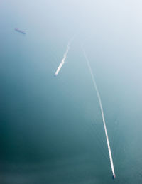 Aerial view of vapor trails in sea